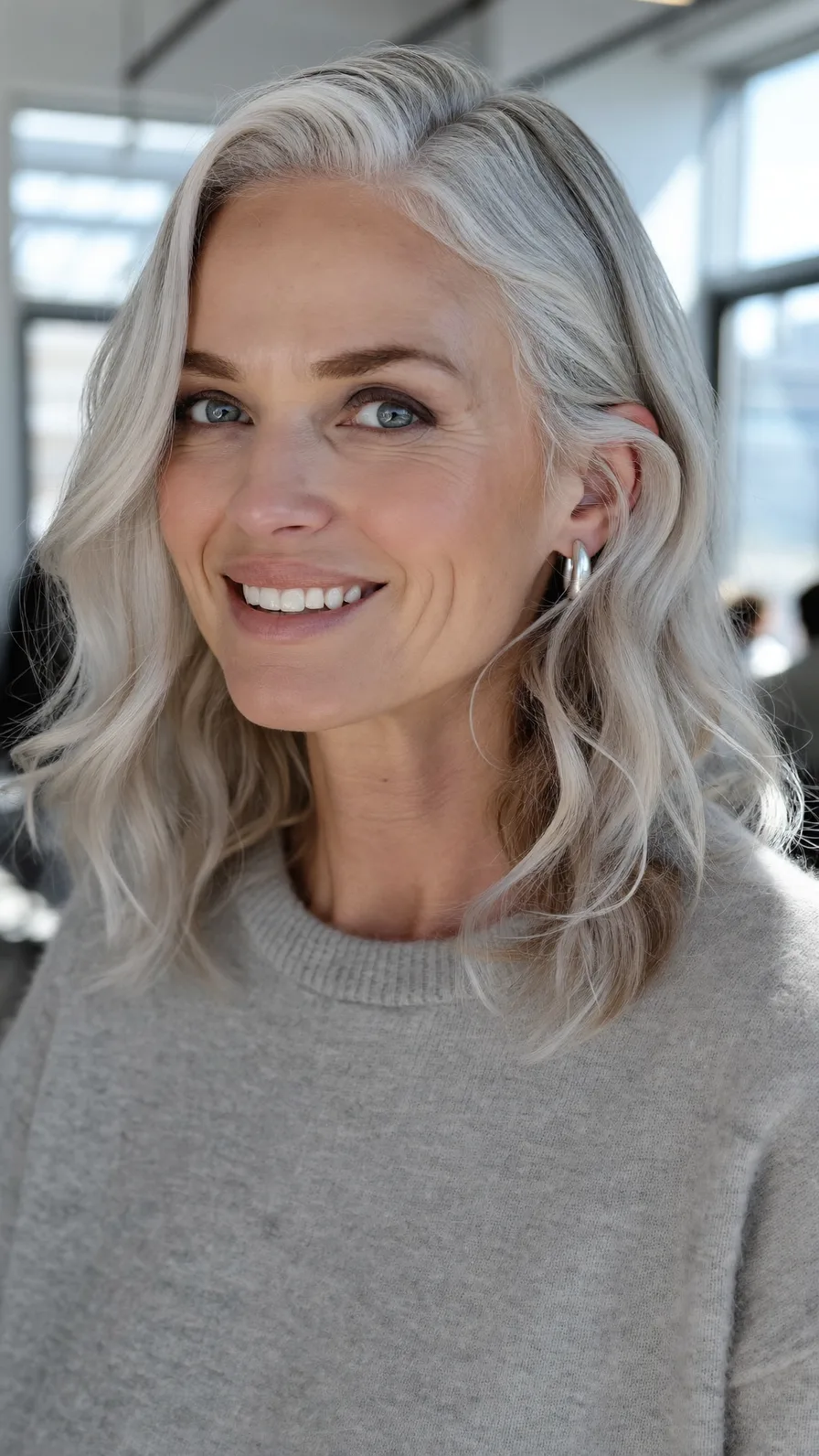 Elegant Silver Blonde Shoulder-Length Wavy Layers Hairstyle
