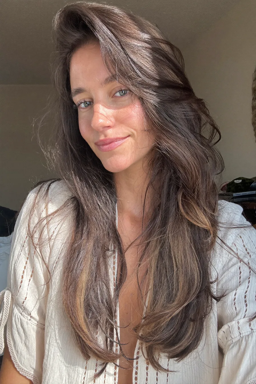 Soft and Voluminous Long Layered Cut with Side-Swept Bangs