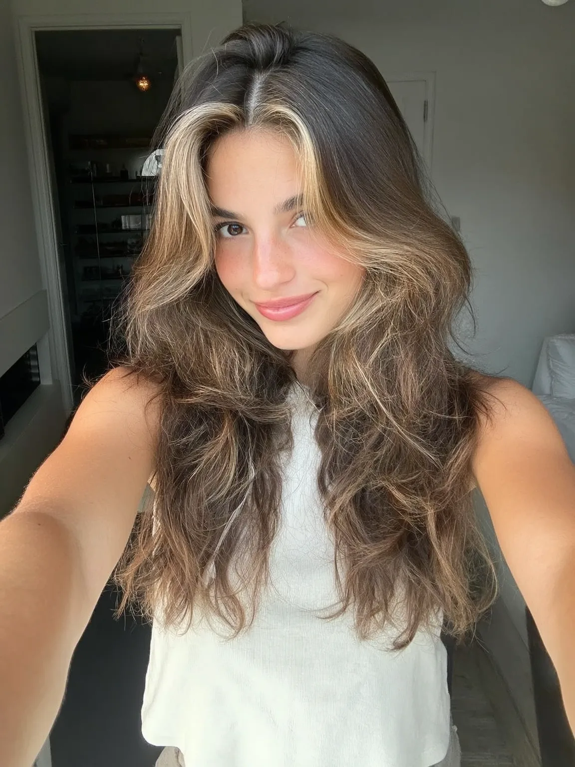 Layered Waves with Brunette Base and Blonde Money-Piece Highlights