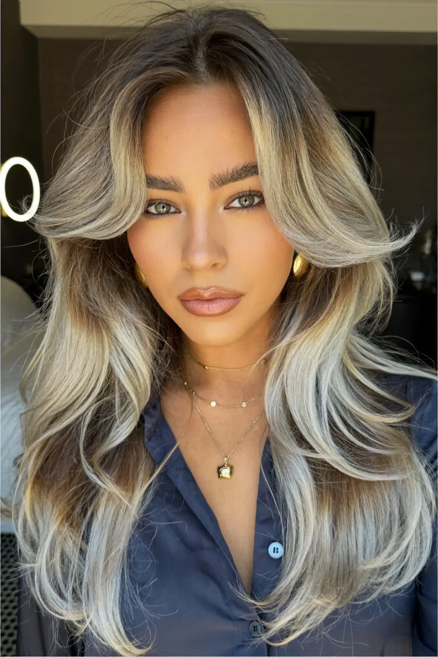 Voluminous Balayage Blonde Long Layered Hair with Feathered Ends