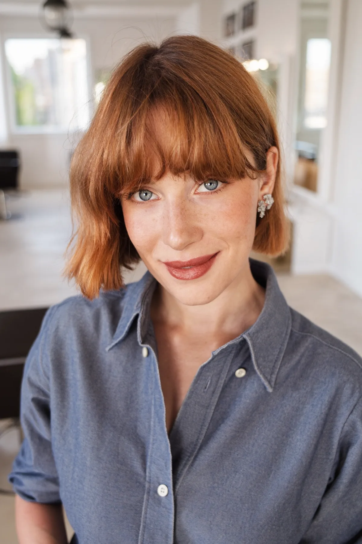 Sleek Strawberry Blonde Chin-Length Bob with Full Fringe Bangs