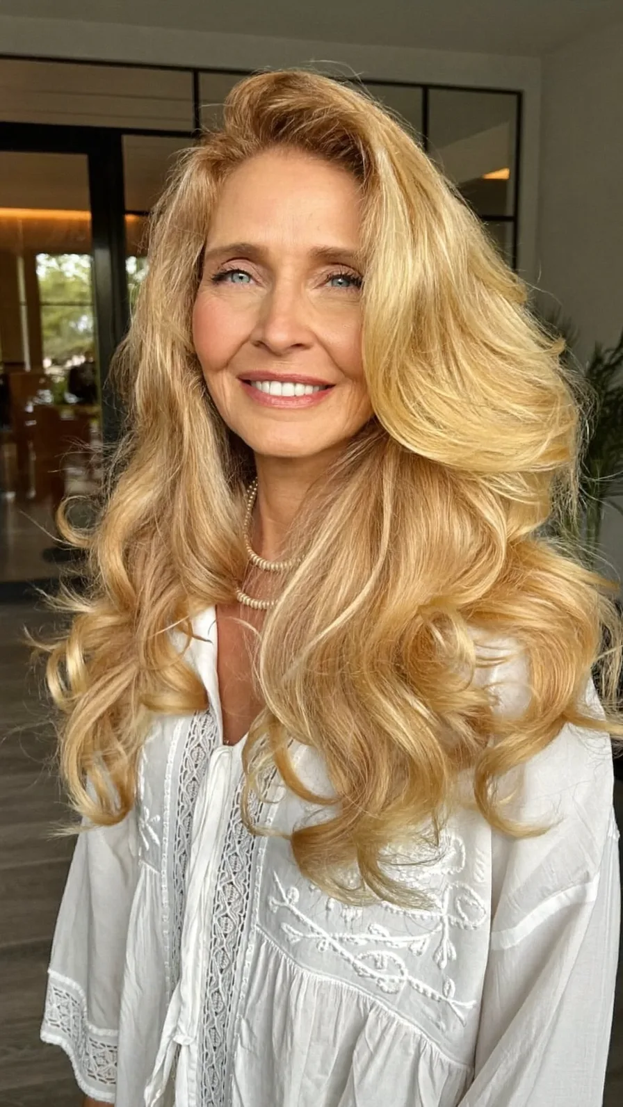 Elegant Long Layered Blonde Hairstyle with Voluminous Waves