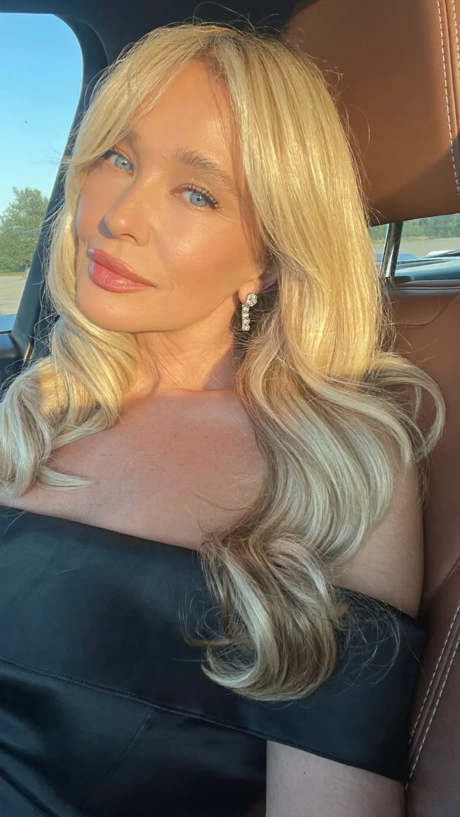 Golden Blonde Long Layers with Curtain Bangs and Flowing Waves