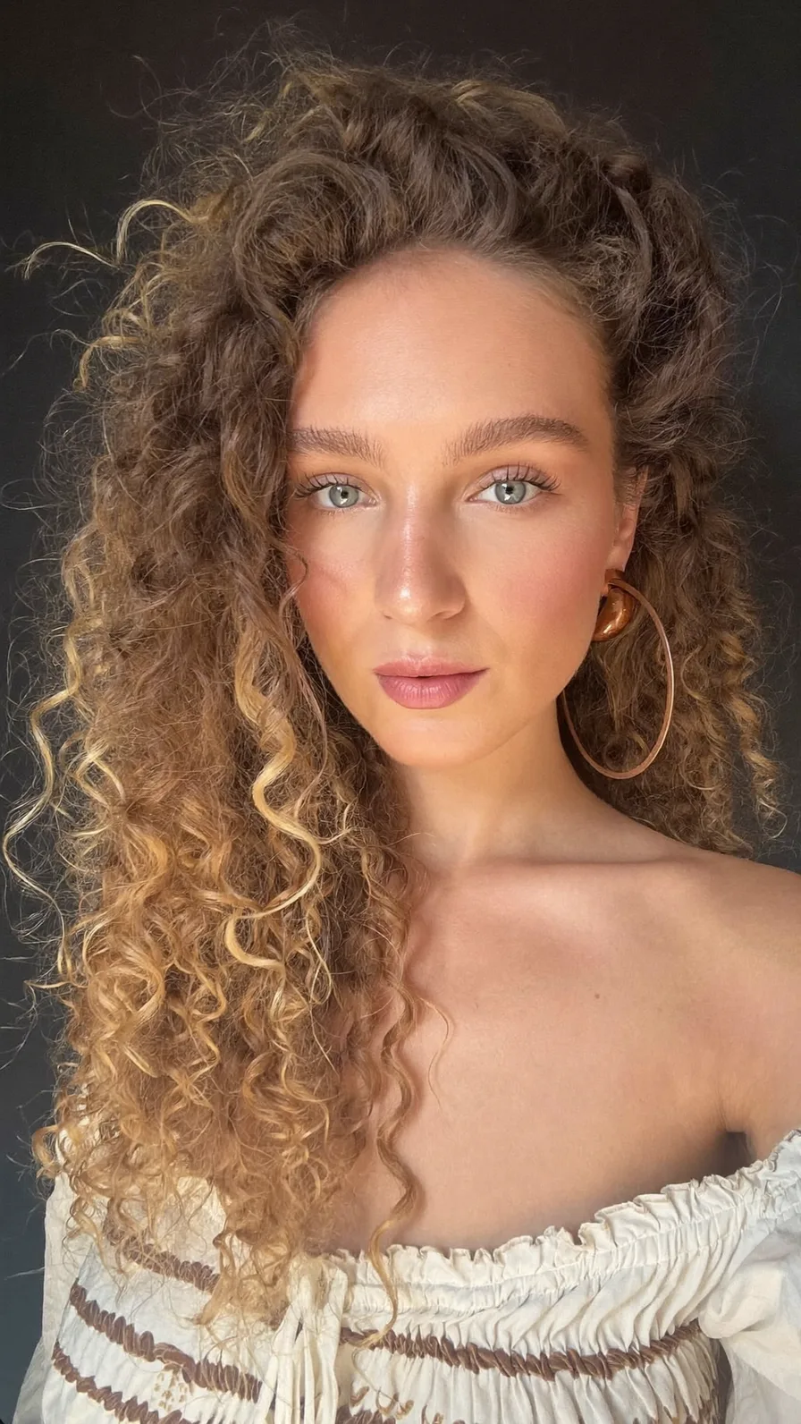 Voluminous Long Layered Curls with Golden Blonde Highlights