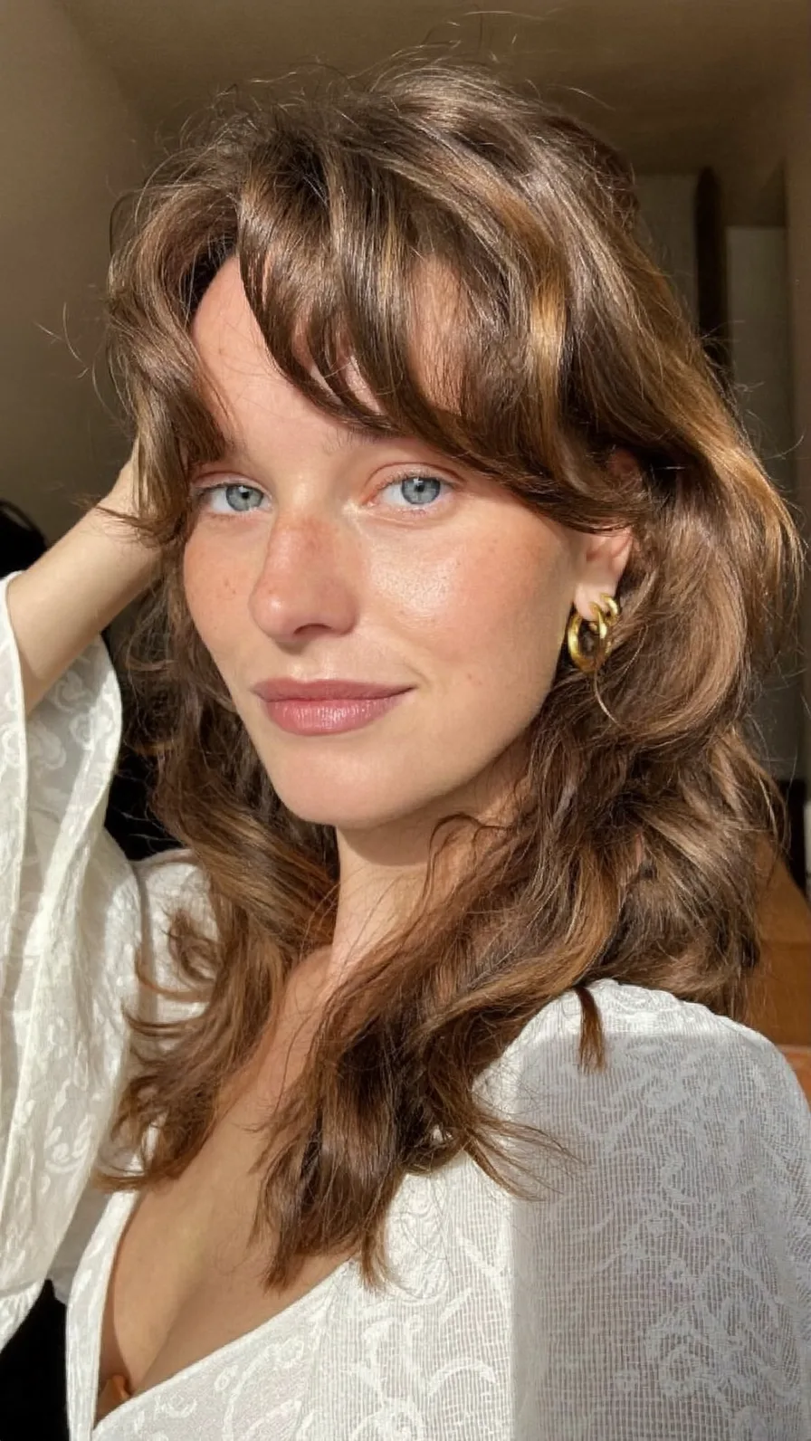 Soft Wavy Medium Hair with Feathered Layers and Curtain Bangs