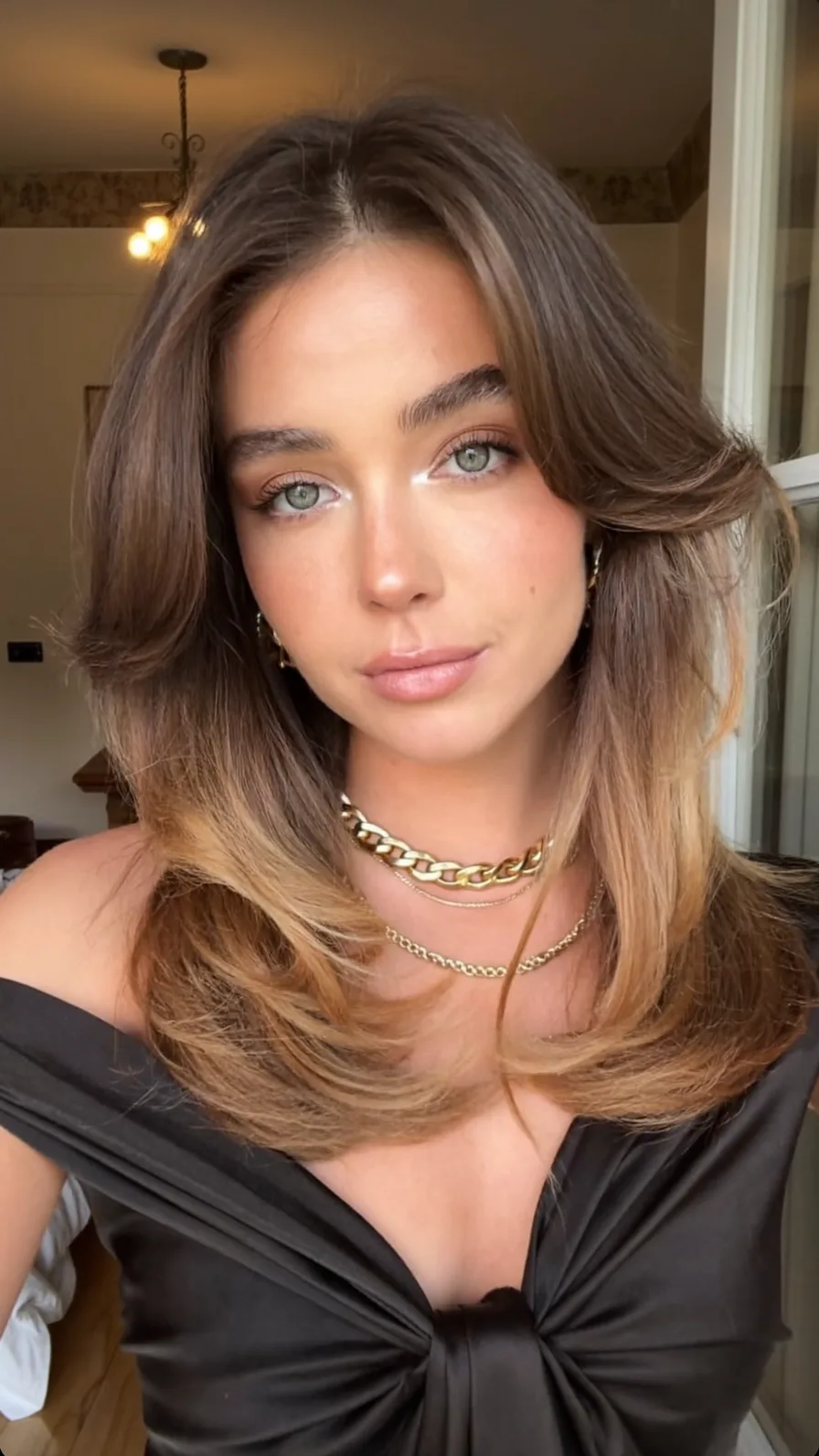 Medium Length Long Layers with Voluminous Flicked Curtain Bangs