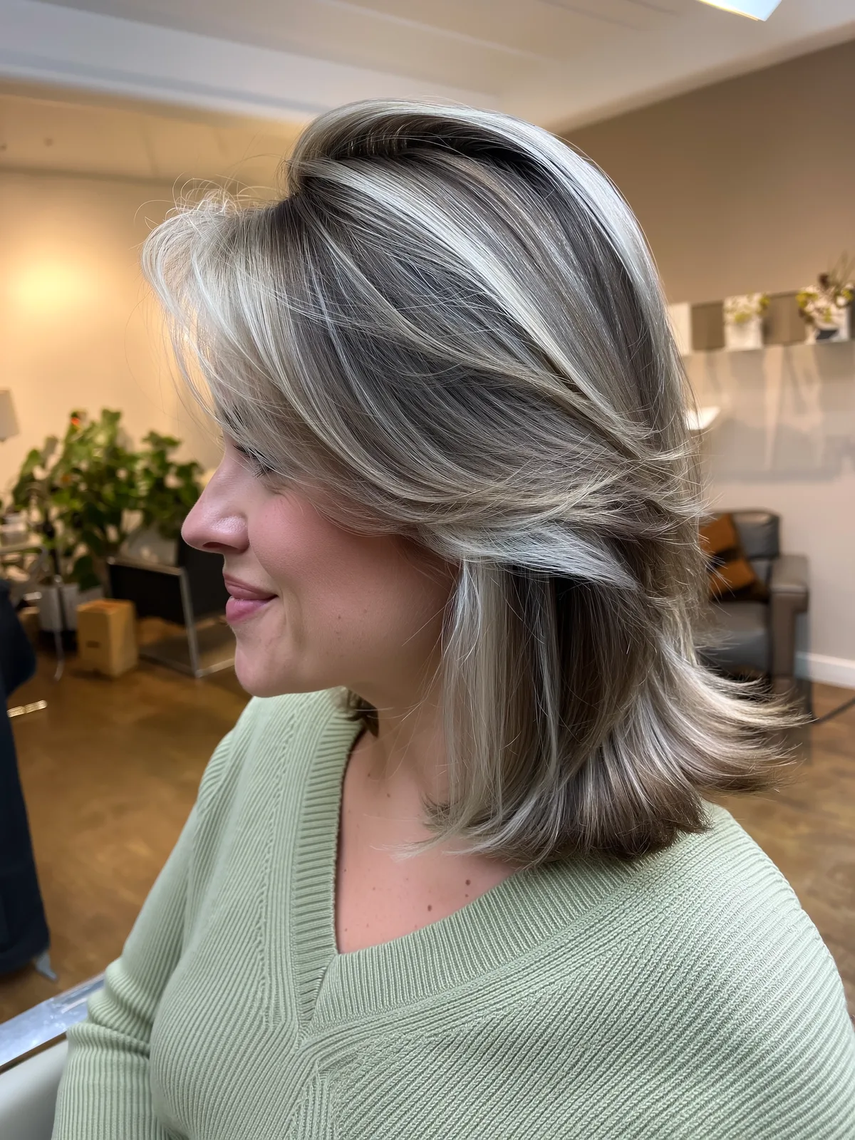Shoulder-Length Ash Blonde Feathered Layers with Side Bangs