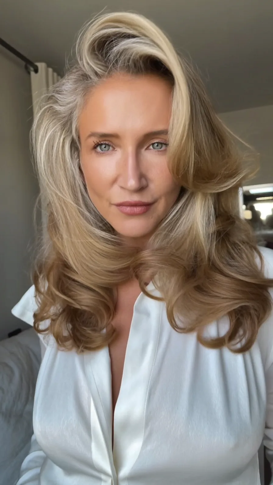 Luxurious Voluminous Ash Blonde Blowout with Side-Swept Layers