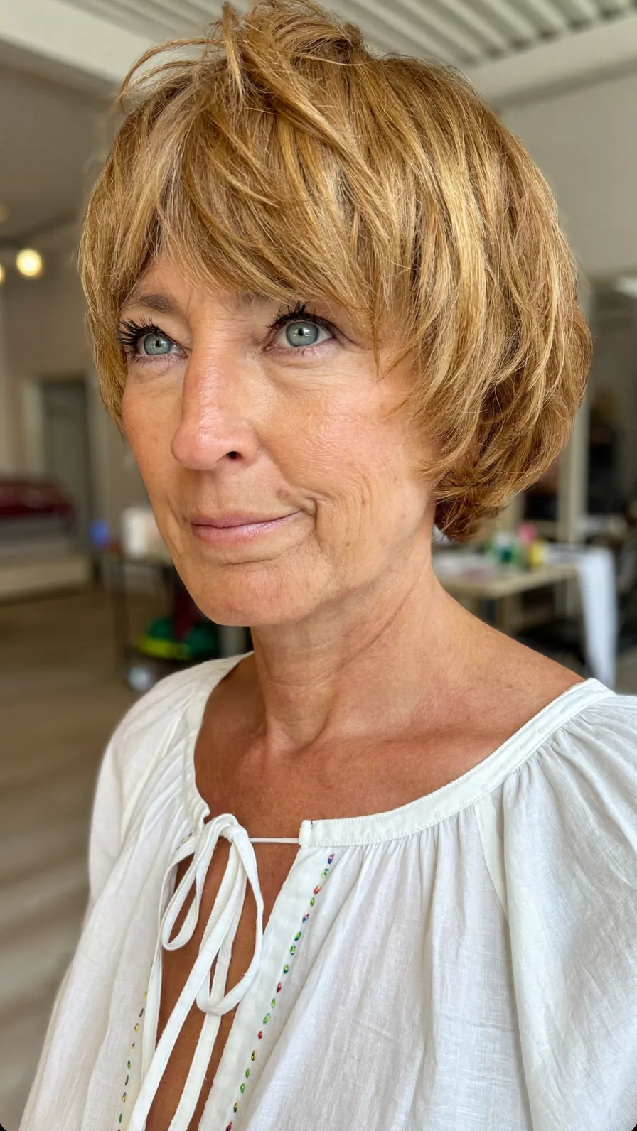 Short Layered Honey Blonde Hair with Side-Swept Bangs
