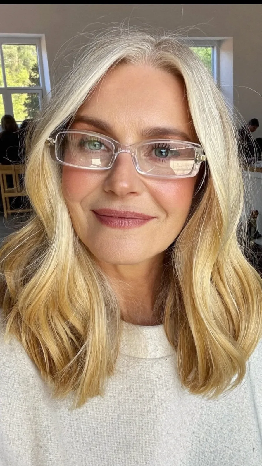 Soft Wavy Blonde Long Layers with Center Part and Glasses