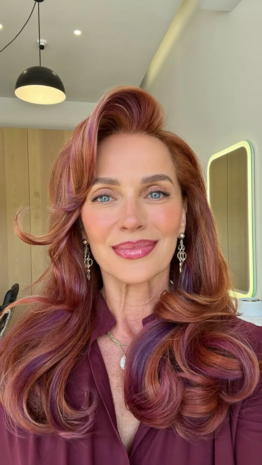 Voluminous Long Layered Copper Red Hairstyle with Side-Swept Bangs