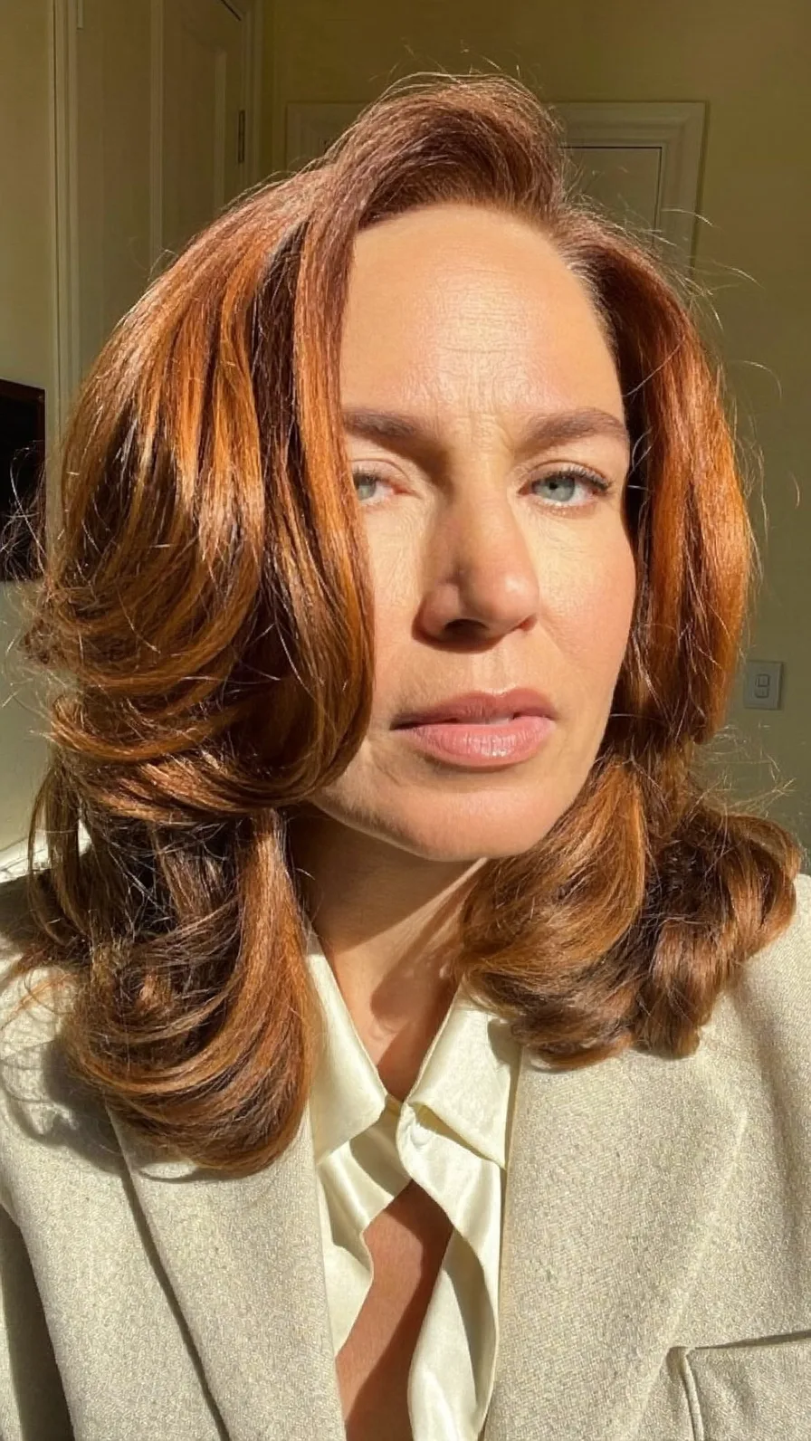 Voluminous Shoulder-Length Copper Red Feathered Layered Hairstyle