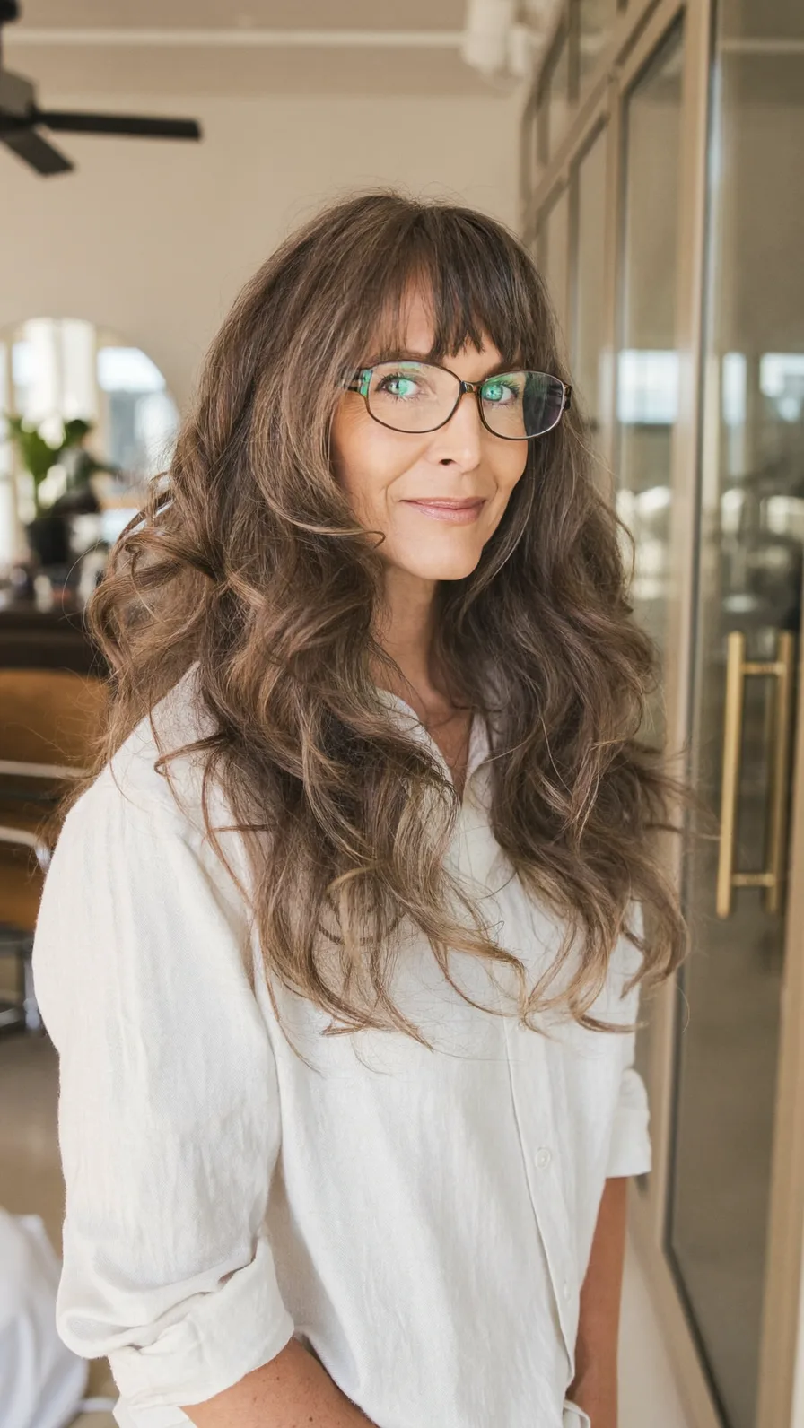 Voluminous Wavy Long Layers with Blunt Bangs for Mature Faces