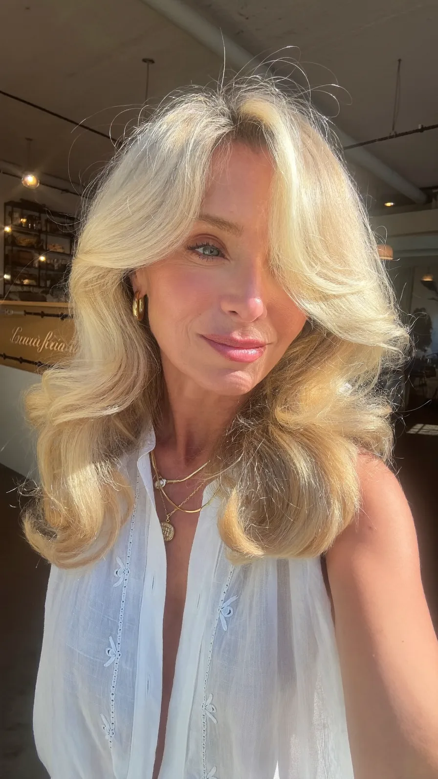 Voluminous Platinum Blonde Long Layers with Curtain Bangs