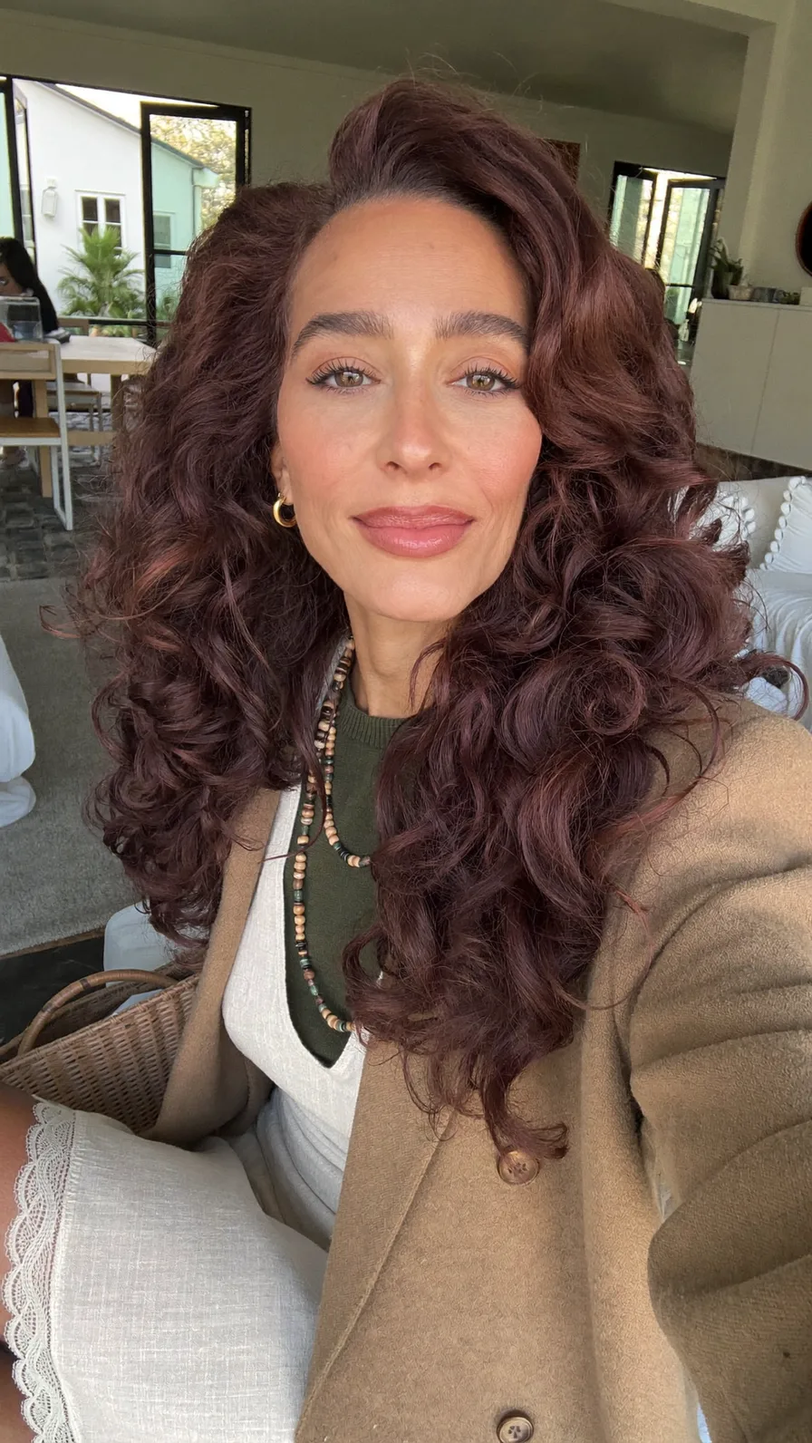 Voluminous Deep Auburn Curly Long Layers with Side-Swept Bangs