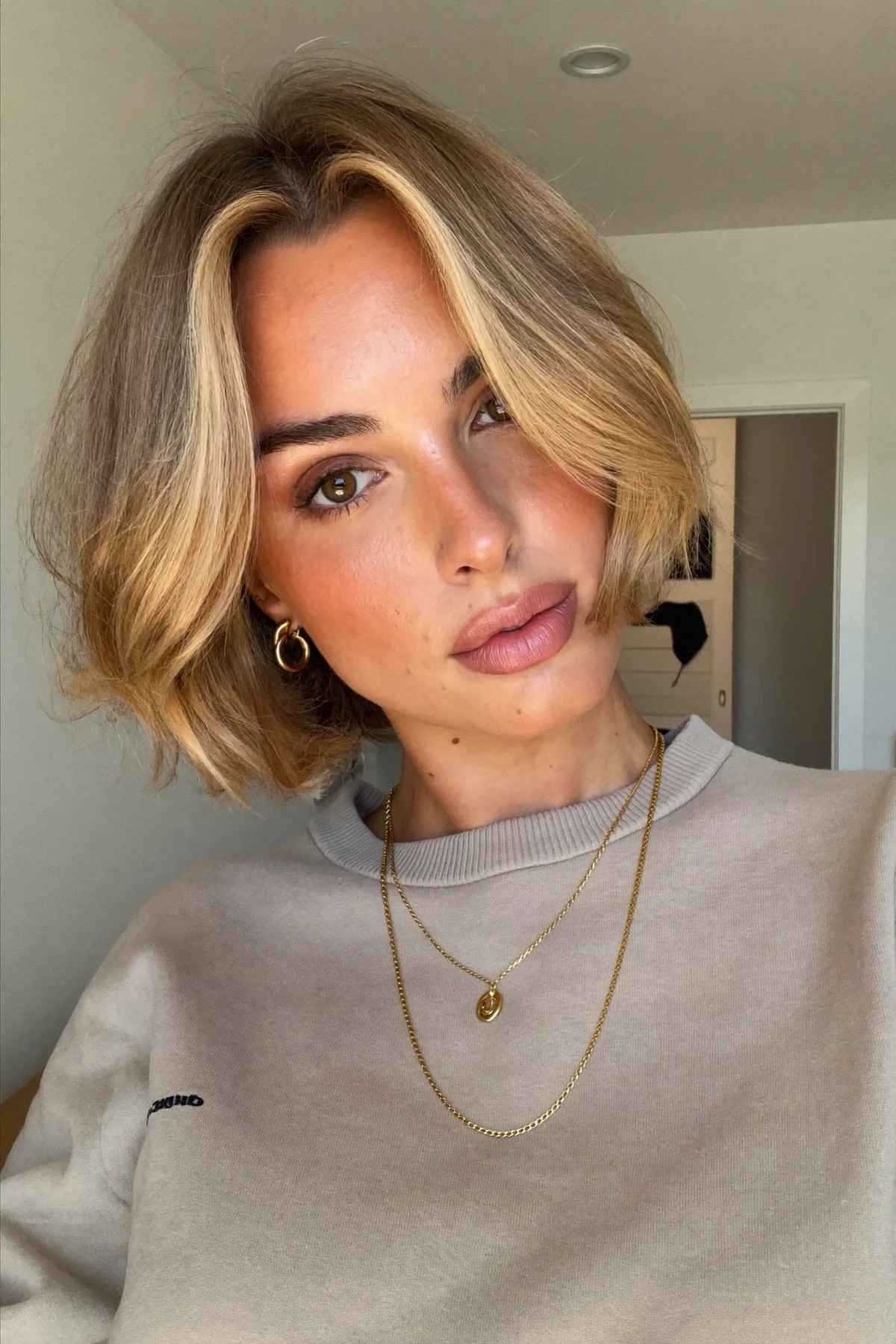 Sleek Honey Golden Blonde Chin-Length Bob with Curtain Bangs