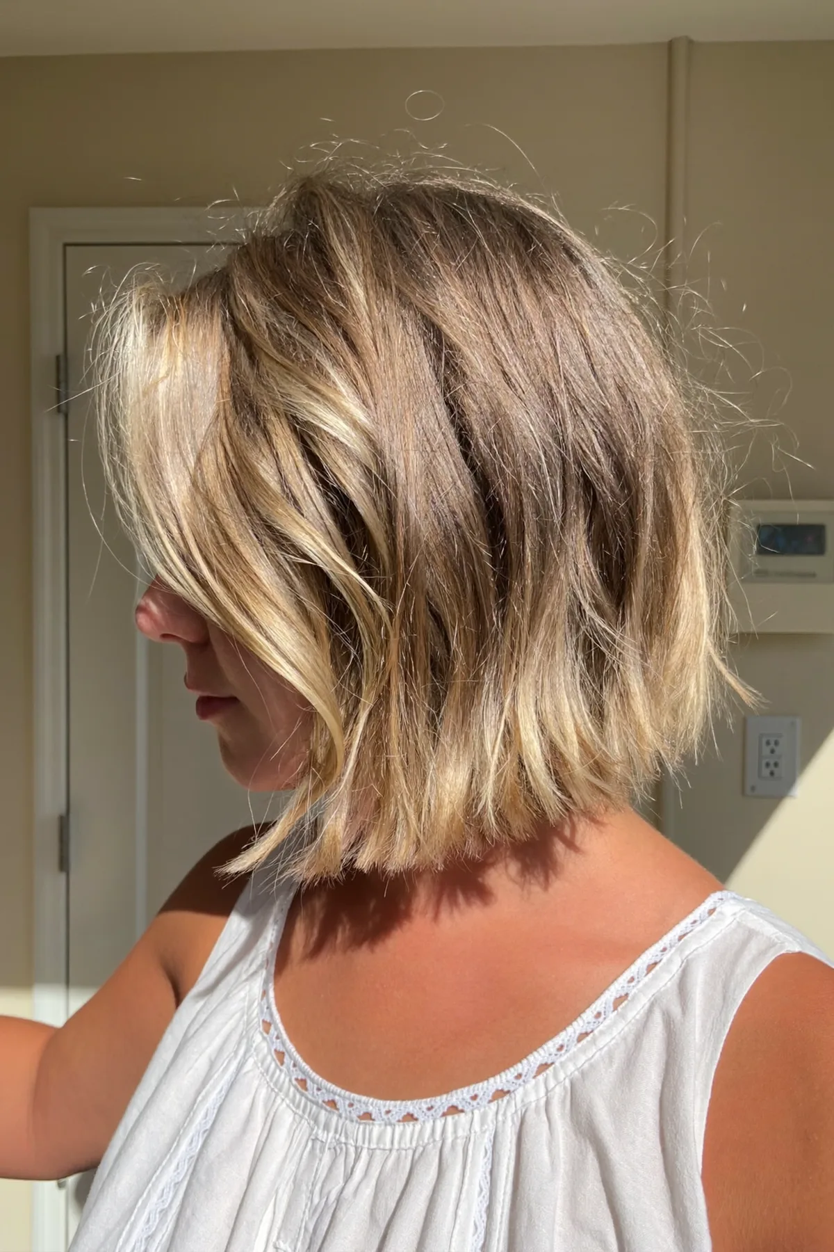 Honey Golden Blonde Shoulder-Length Bob with Wavy Texture and Curtain Bangs