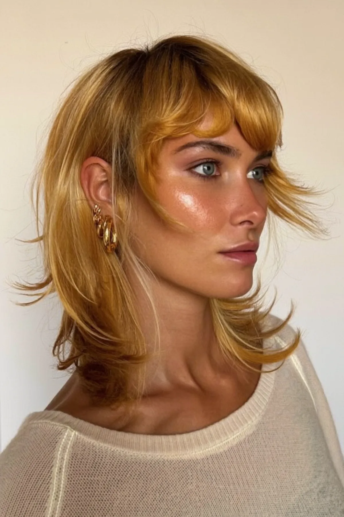 Honey Golden Blonde Shoulder-Length Wavy Shag with Full Fringe Bangs