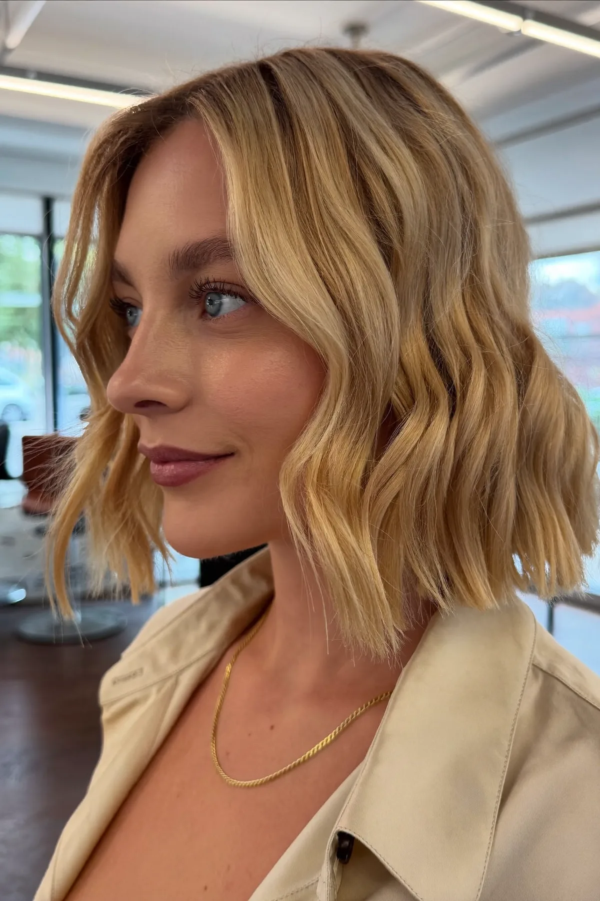 Honey Golden Blonde Wavy Bob with Curtain Bangs and Blended Balayage