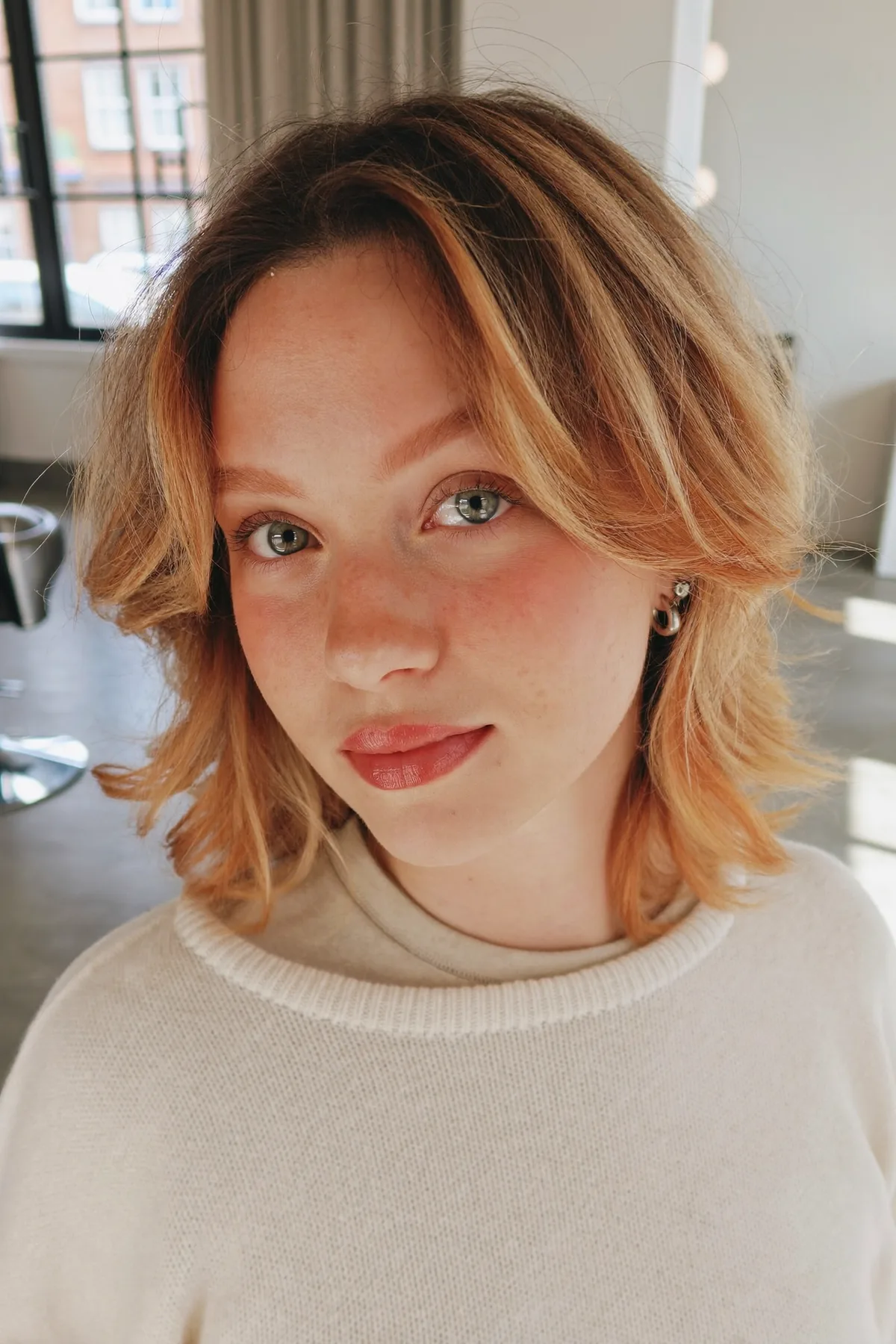 Shoulder-Length Honey Golden Blonde Shag with Curtain Bangs and Balayage