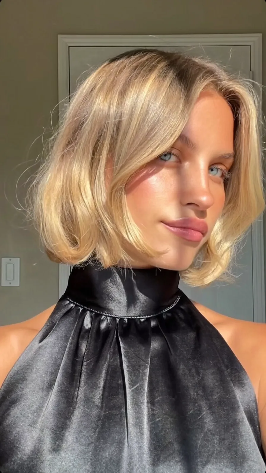 Chin-Length Flicked Bob with Warm Honey Blonde Highlights