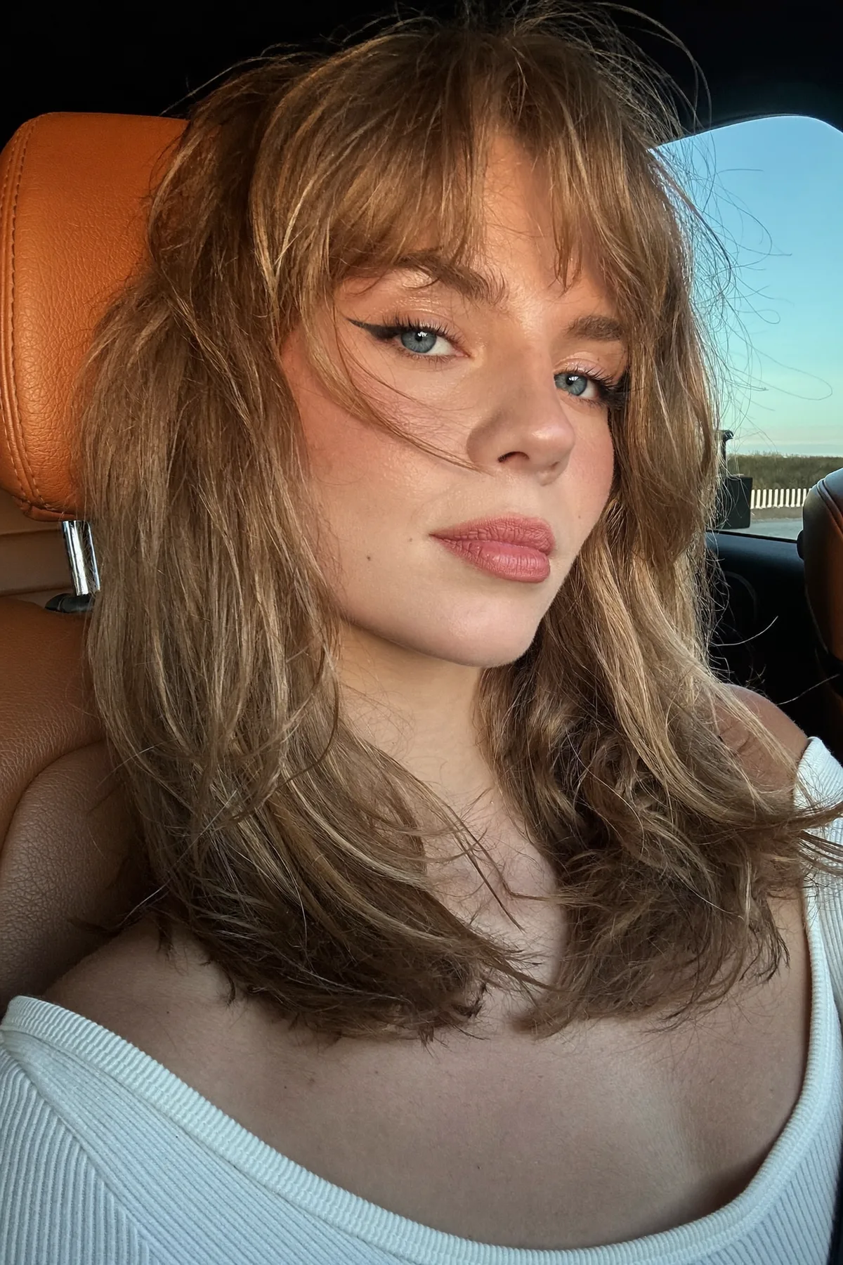 Honey Golden Blonde Shoulder-Length Lob with Curtain Bangs