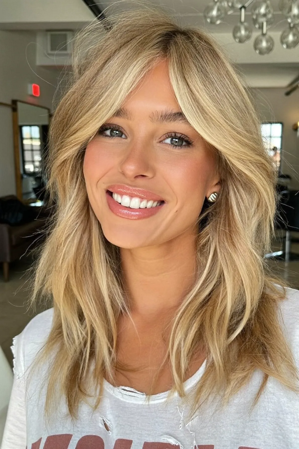 Honey Golden Blonde Wavy Lob with Curtain Bangs and Balayage