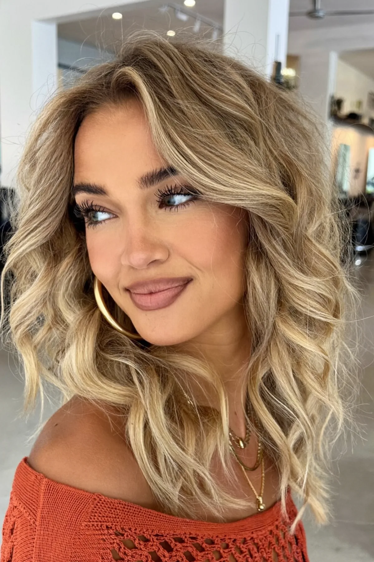 Honey Golden Blonde Wavy Lob with Curtain Bangs and Balayage