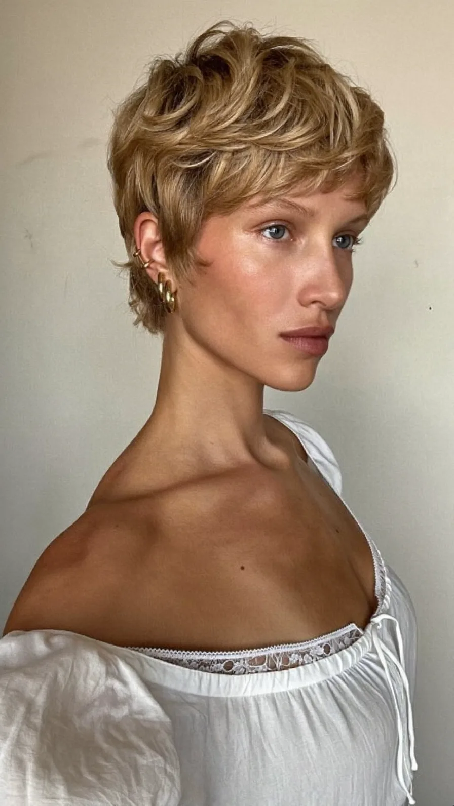 Modern Textured Pixie Cut with Warm Honey Blonde Highlights