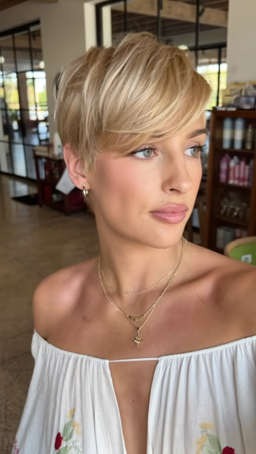 Soft Feathered Honey Blonde Pixie with Side-Swept Bangs