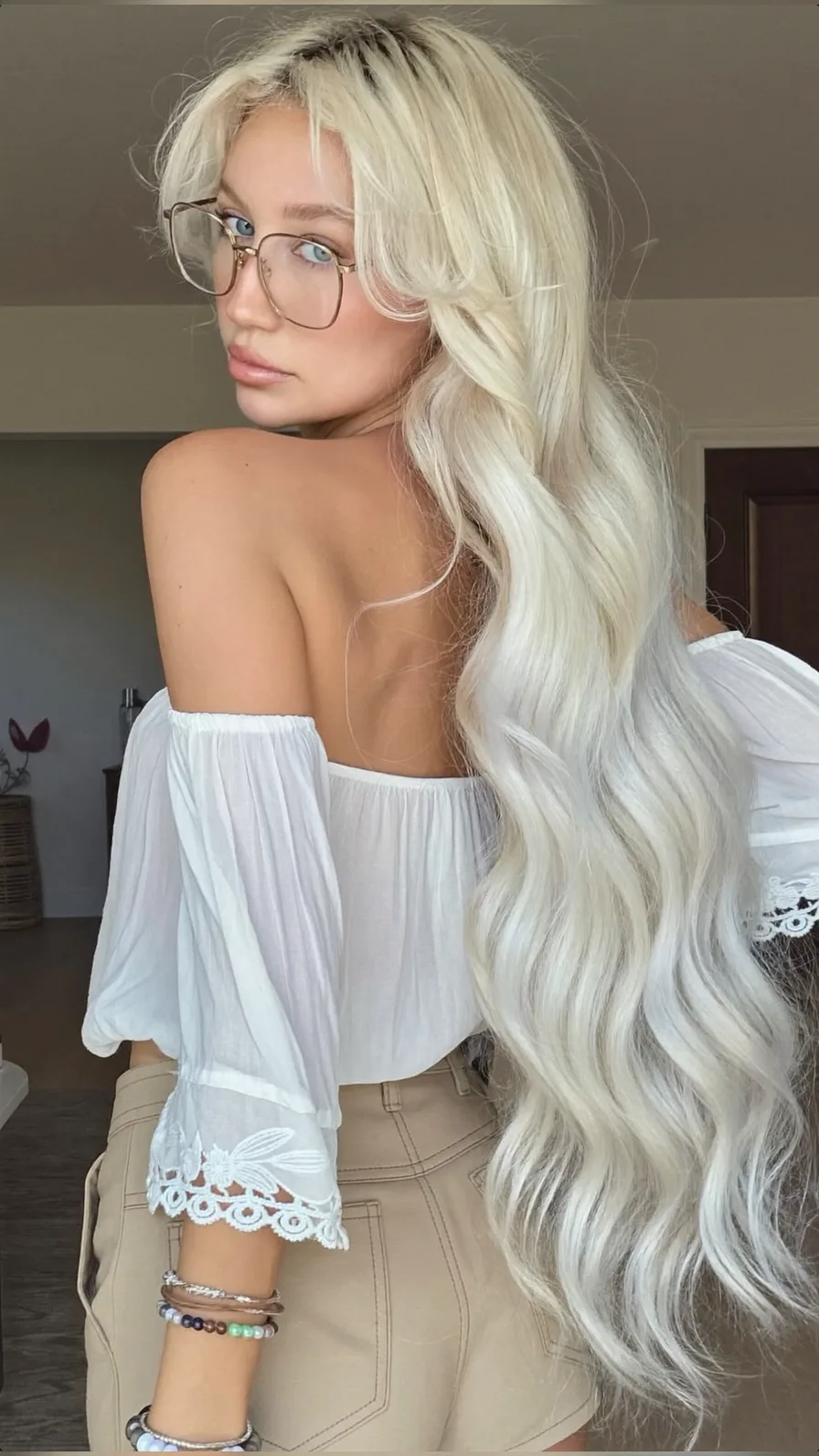 Voluminous Platinum Blonde Long Waves with Curtain Bangs