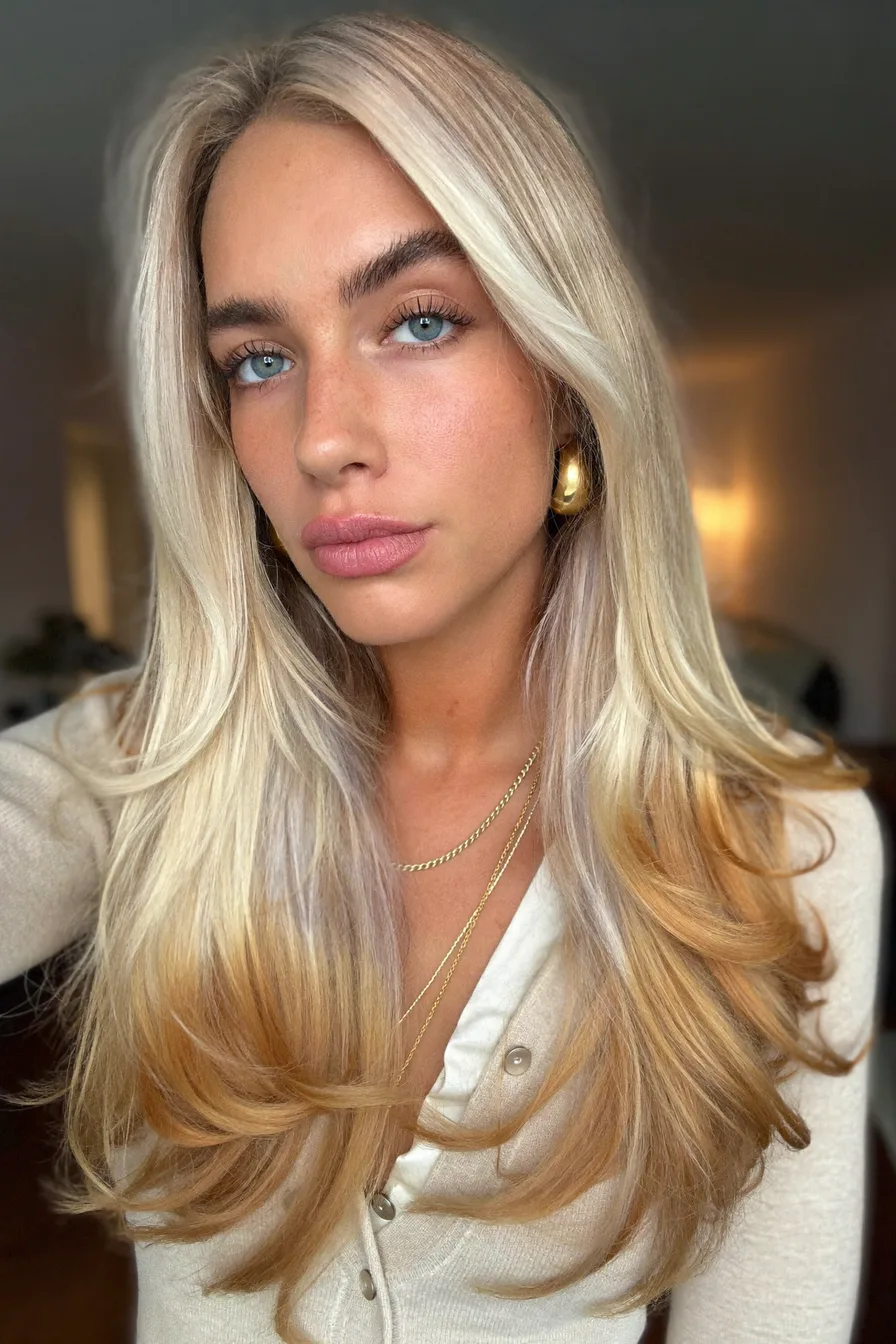 Long Layered Blonde Hair with Warm Ombre Flicked Ends