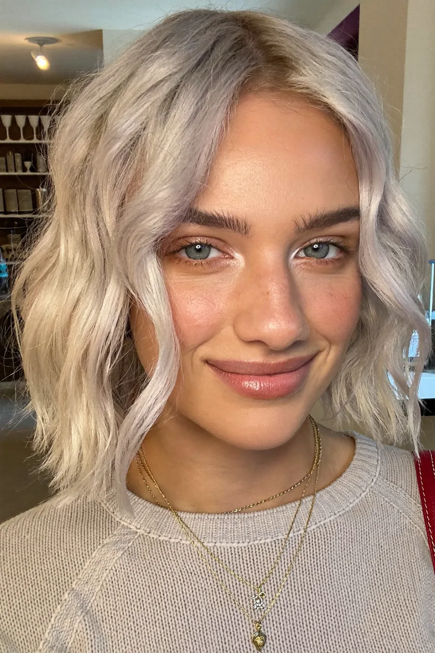 Textured Platinum Blonde Choppy Bob with Side-Swept Bangs