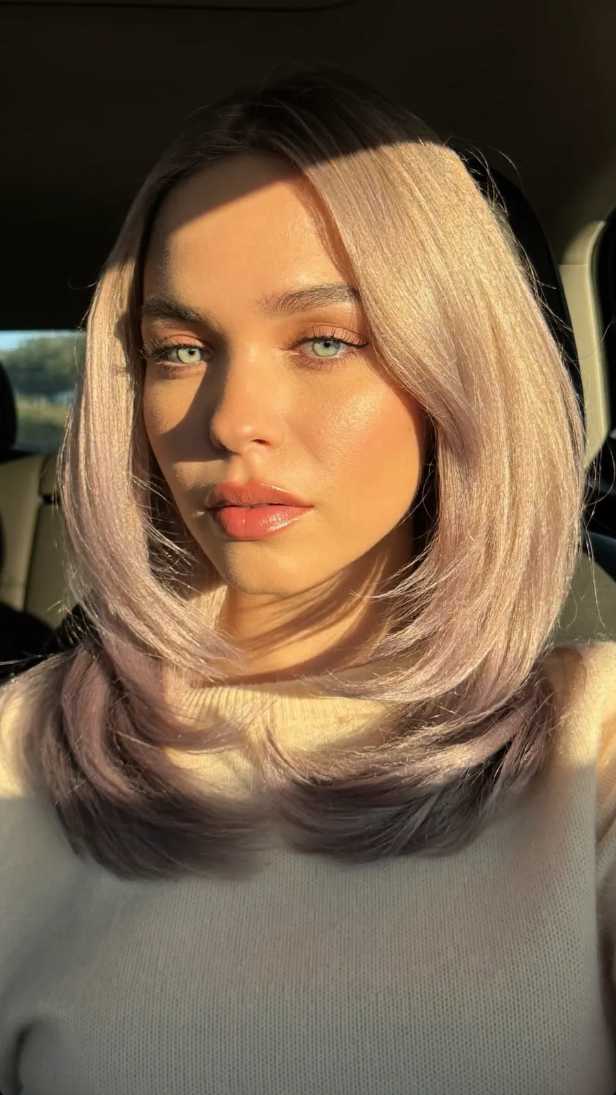 Sleek Shoulder-Length Platinum Blonde with Side-Swept Layers