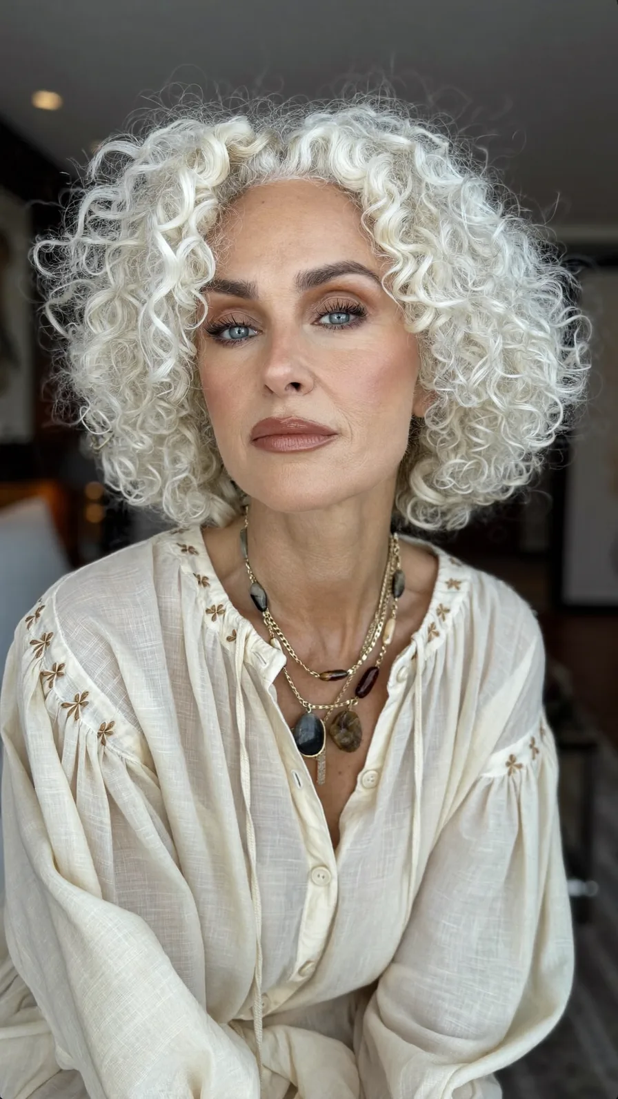 Voluminous Platinum Curly Bob with Defined Oval Face Frame