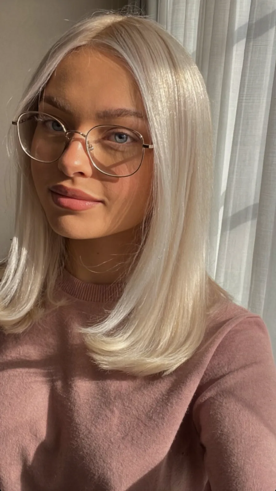 Sleek Medium-Length Platinum Blonde Layers with Rounded Ends