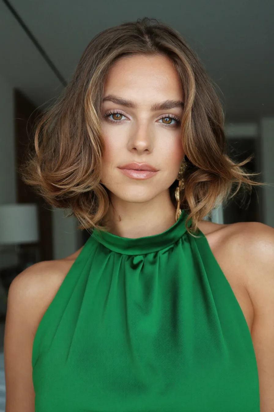 Voluminous Wavy Chin-Length Bob with Honey Balayage Highlights