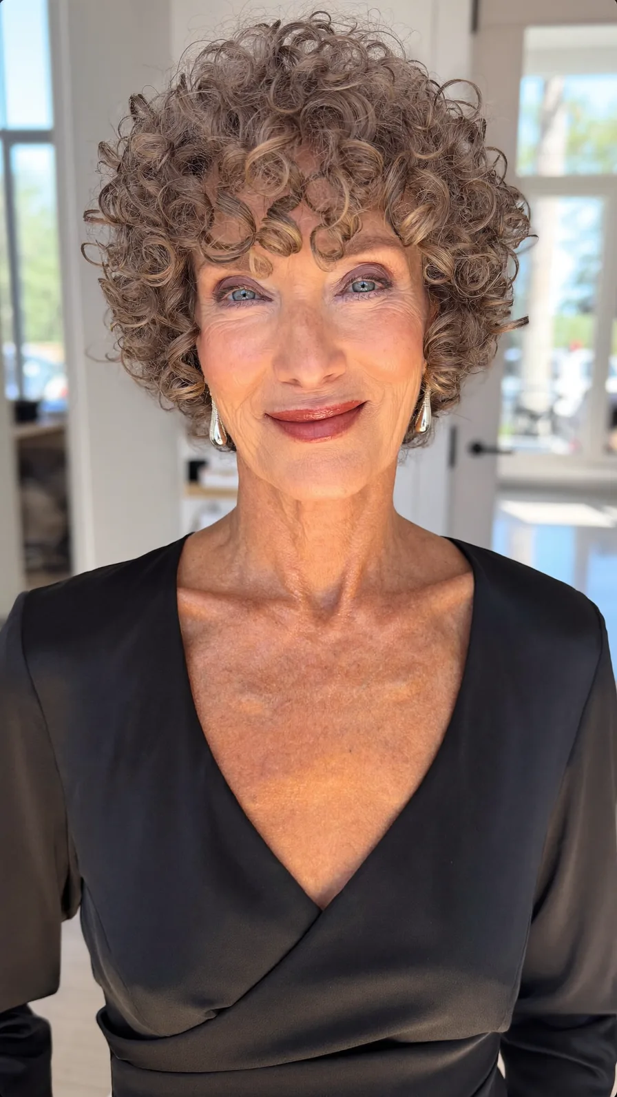 Voluminous Curly Short Layers with Defined Curtain Bangs