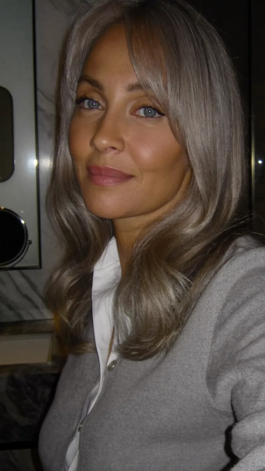 Elegant Long Layered Ash Blonde Hairstyle with Curtain Bangs