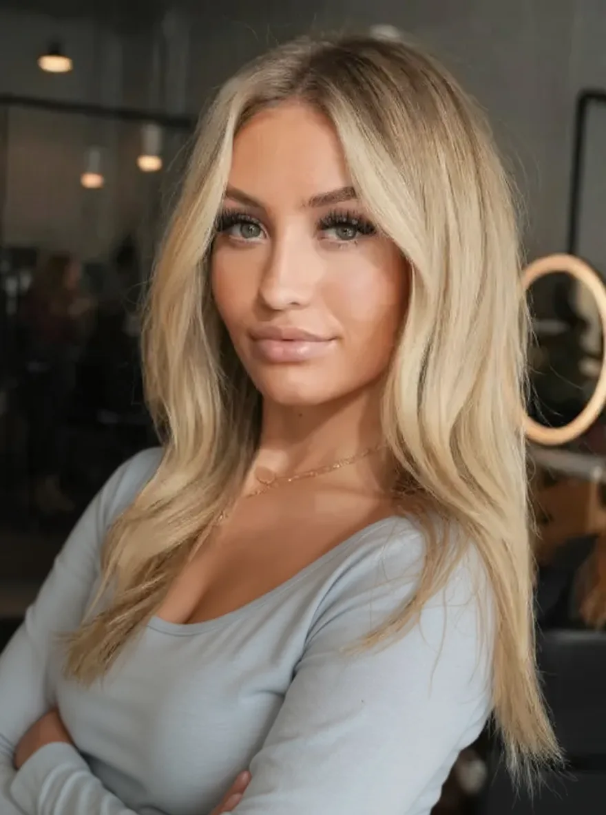 Sandy Blonde Curtain Bangs with Medium Volume Wavy Layers