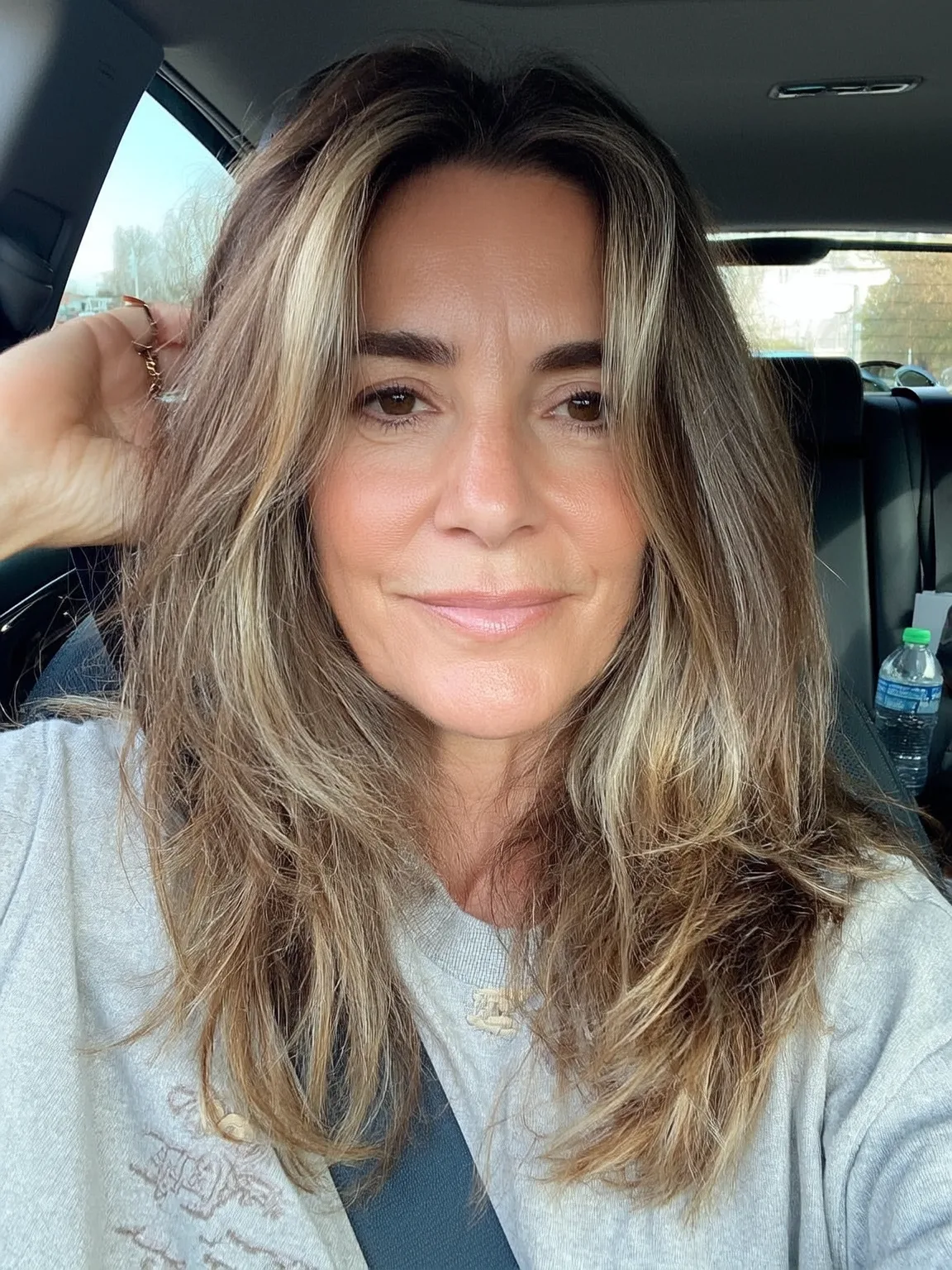 Voluminous Honey Blonde Waves with Long Bangs