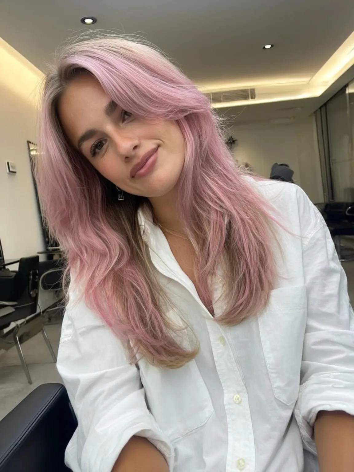 Voluminous Pastel Pink Balayage with Wavy Curtain Bangs