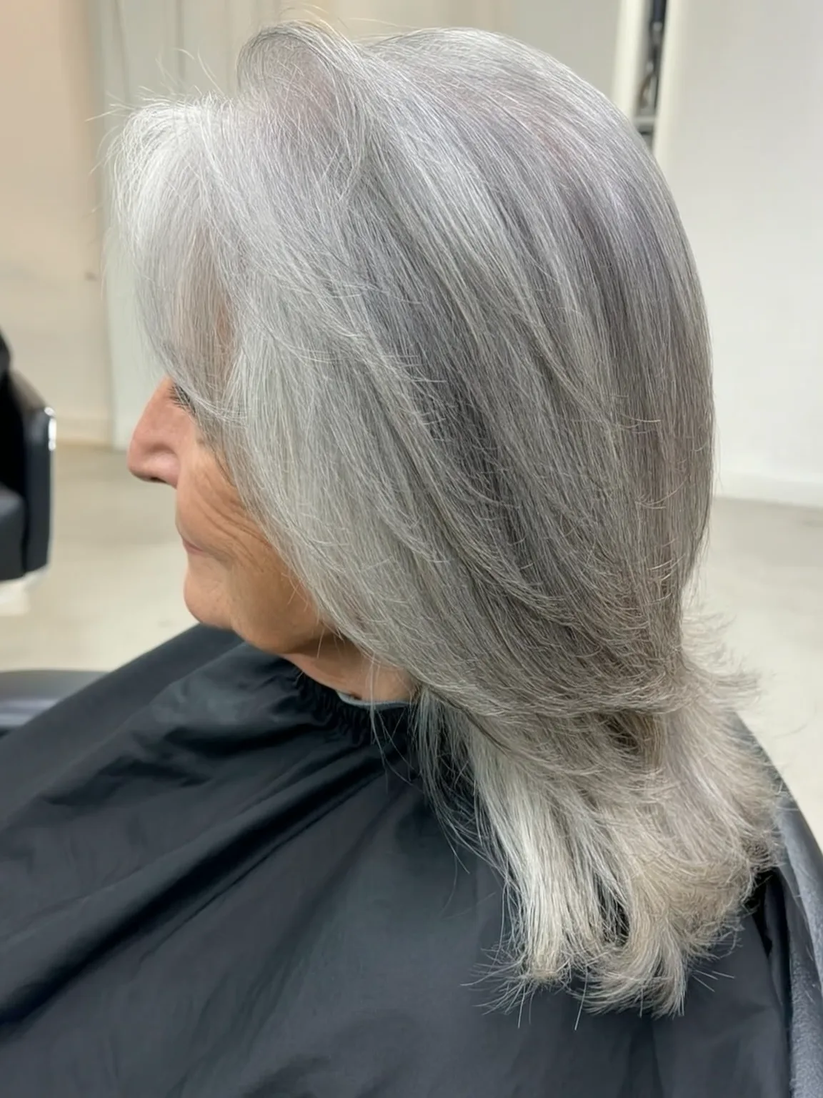 Sleek Silver Frost Layers with Side-Swept Bangs