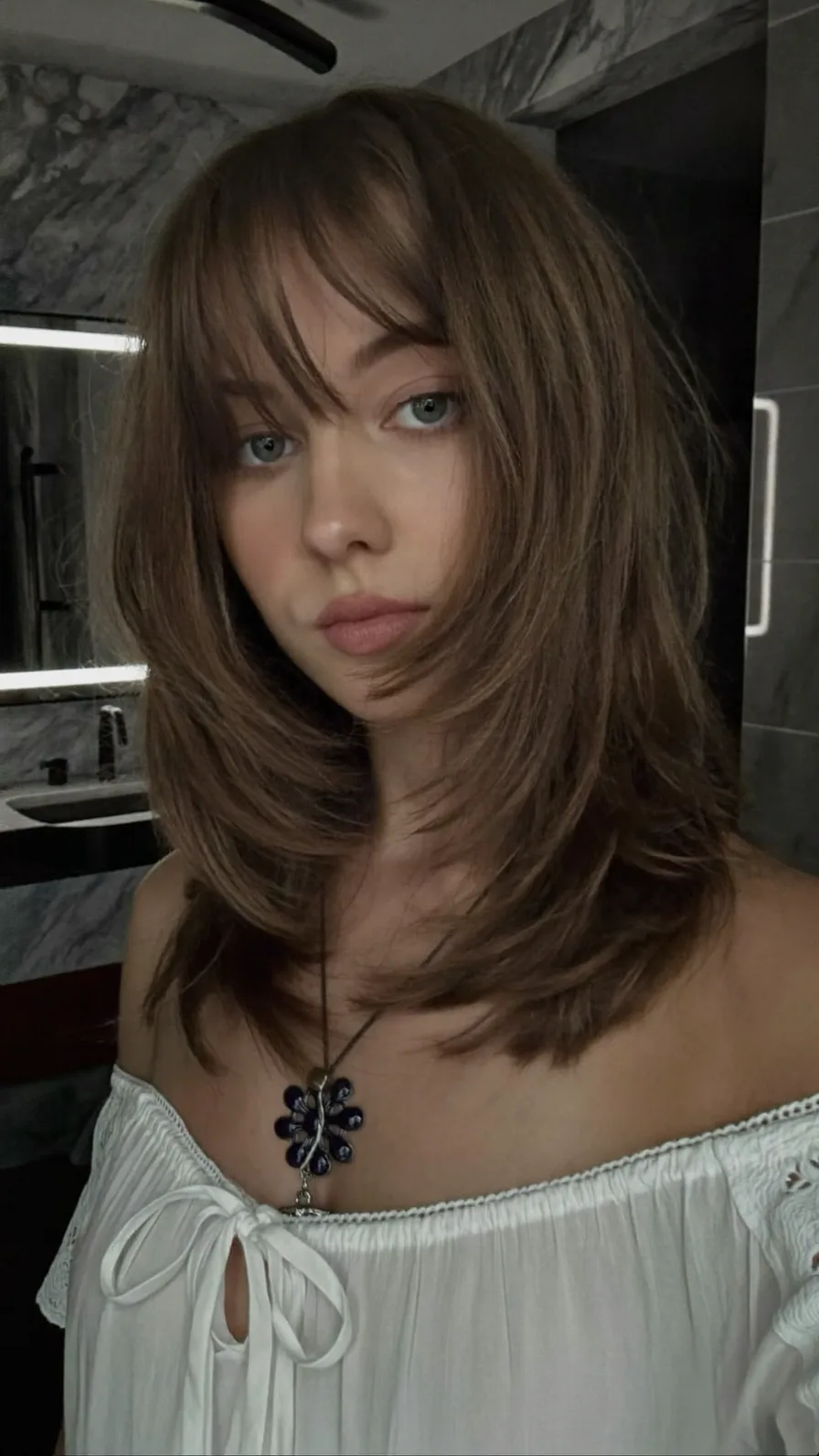 Medium Layered Hair with Feathered Ends and Curtain Bangs