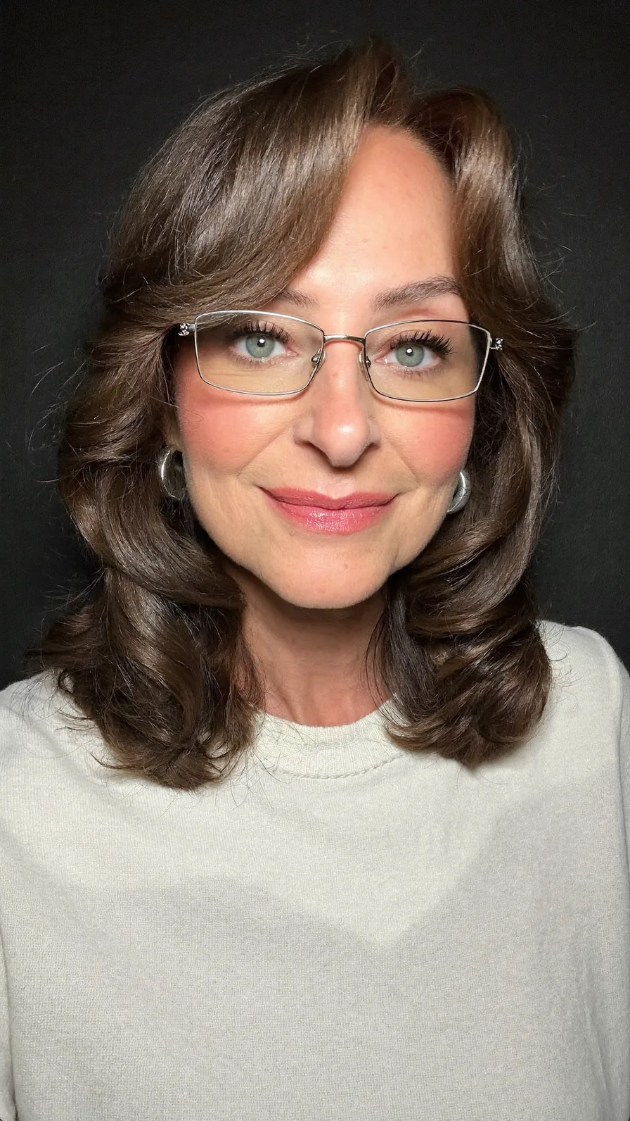 Classic Voluminous Medium-Length Layered Hairstyle with Curtain Bangs