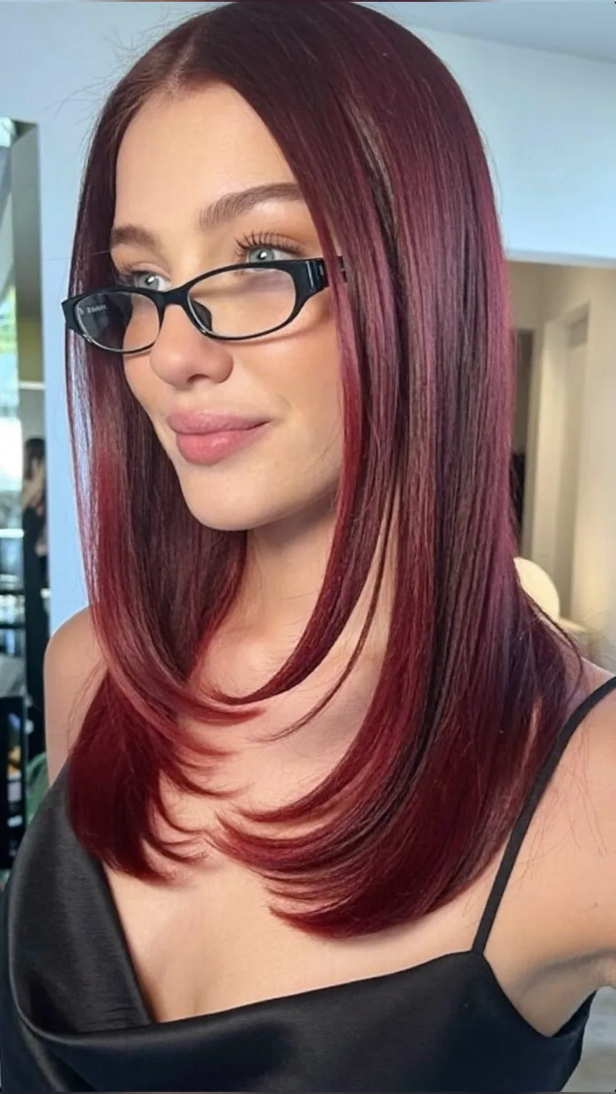 Sleek Medium-Length Burgundy Hair with Long Layers and Flicked Ends