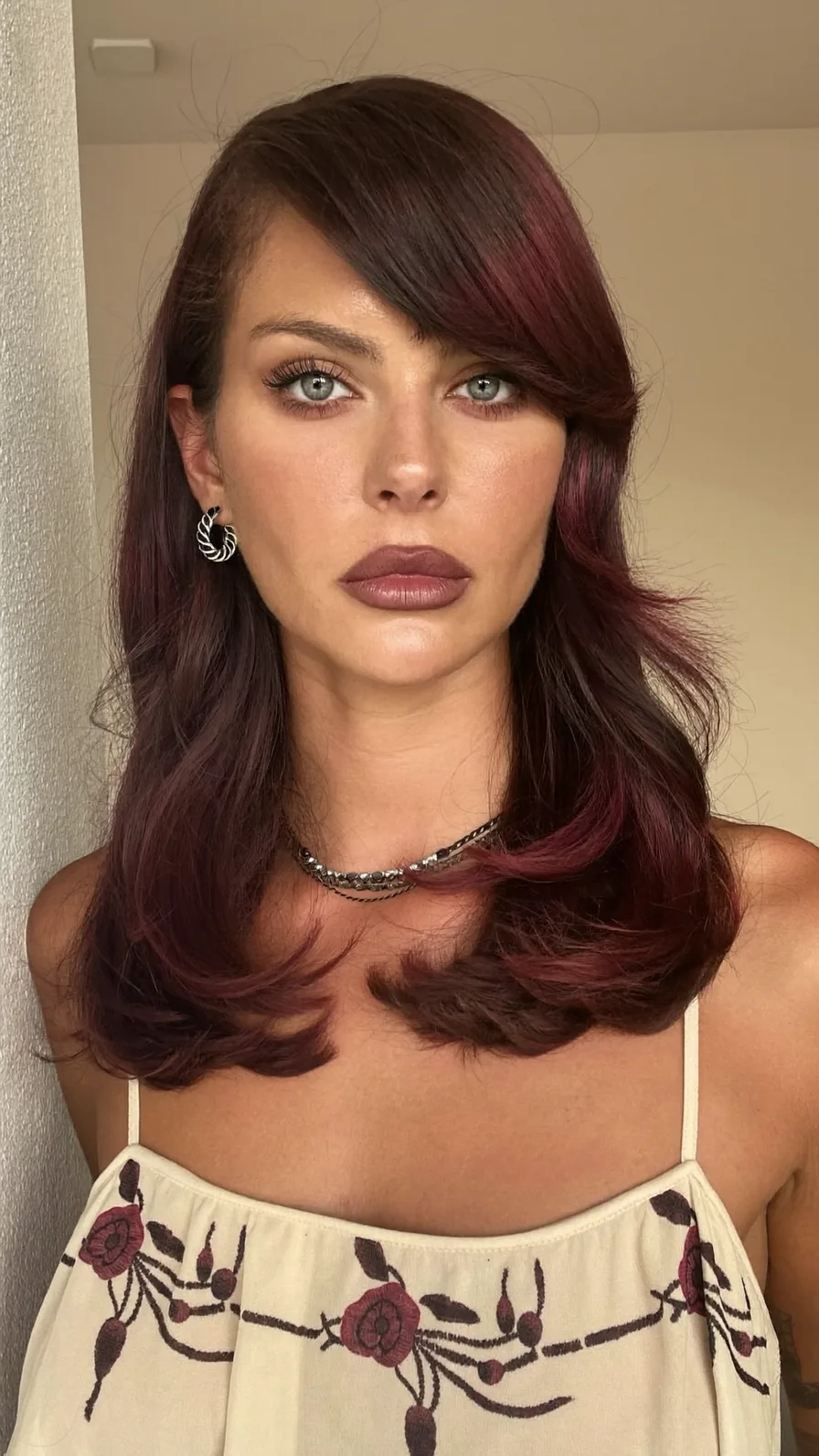 Medium Length Wavy Deep Burgundy Hair with Side-Swept Layers