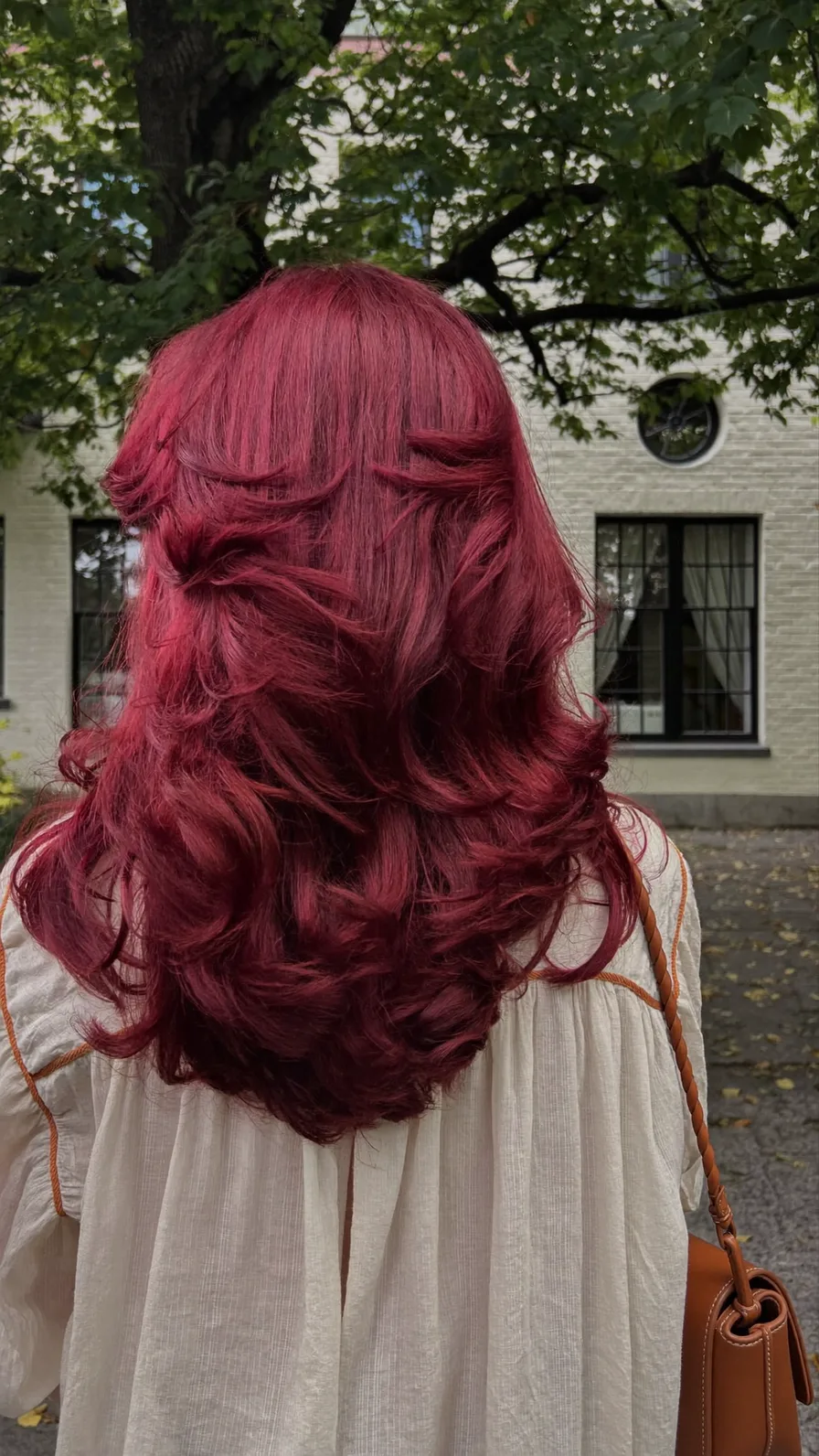 Voluminous Deep Burgundy Red Medium Layered Hairstyle