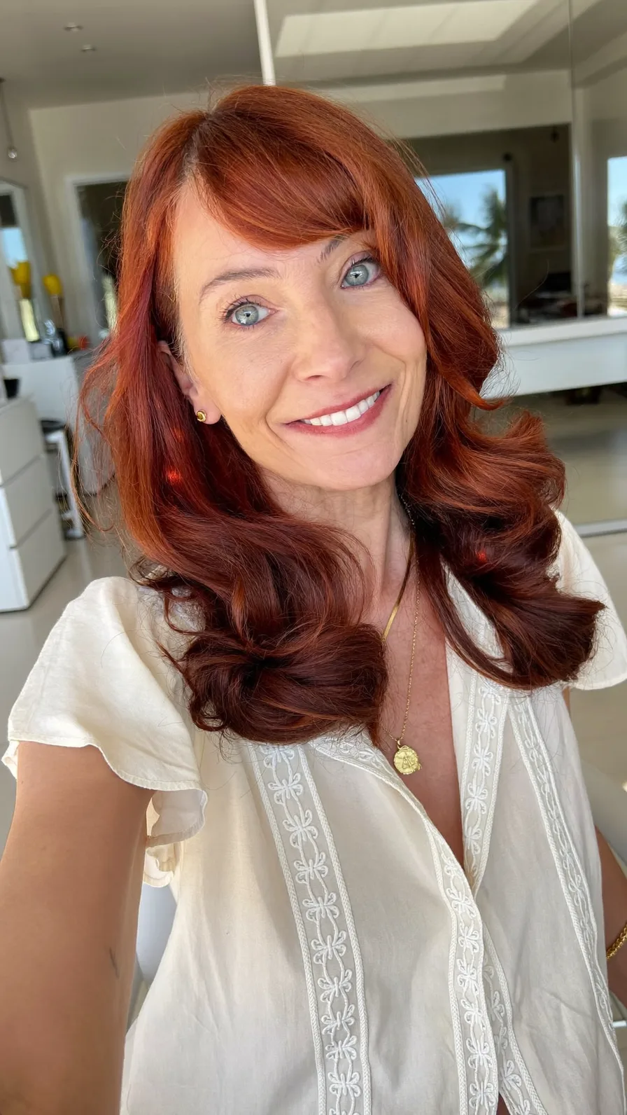 Voluminous Side-Swept Auburn Layers with Rounded Ends