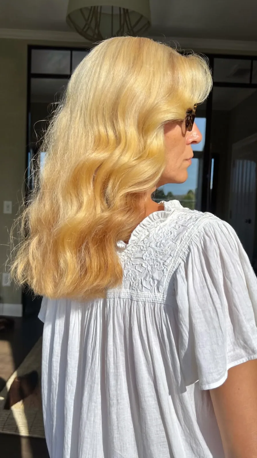 Classic Golden Blonde Medium-Length Wavy Hairstyle with Curtain Bangs